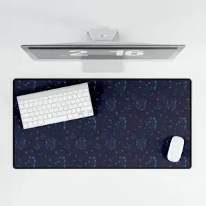 A large desk mat featuring the Woodland Bloom floral pattern in deep blue, with soft florals in warm autumn shades. Shown flat on a tidy desk with accessories.