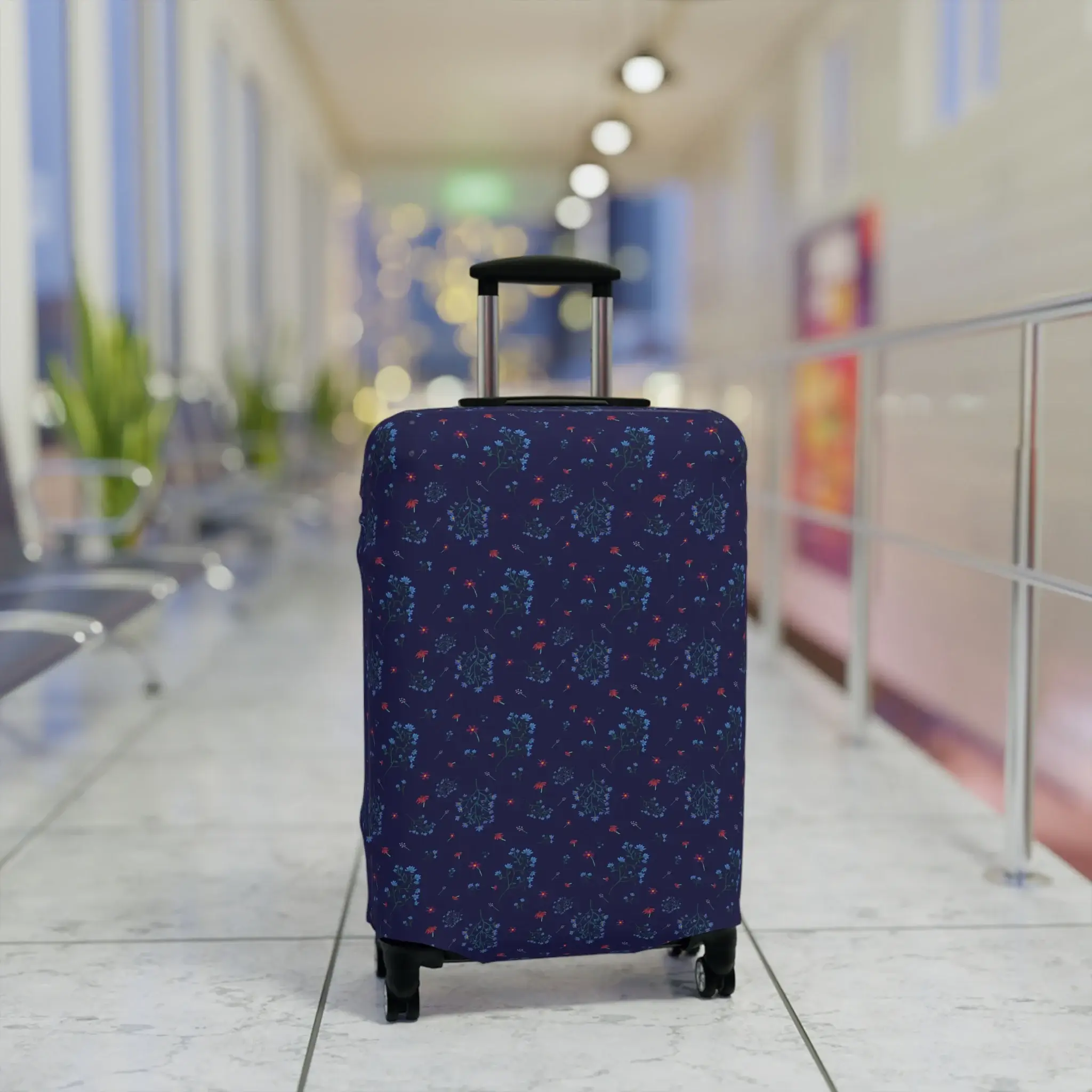 Close-up of a navy blue floral luggage cover from the Woodland Bloom collection, snugly fitted on a suitcase.