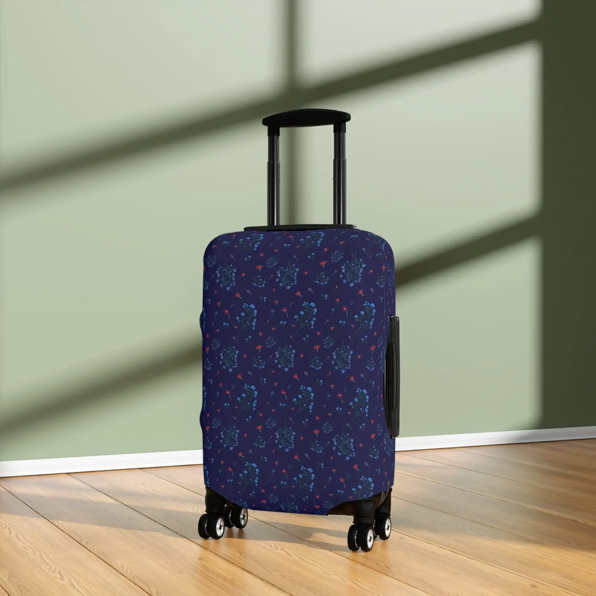 Close-up of a 21" x 14" navy blue floral luggage cover from the Woodland Bloom collection, snugly fitted on a suitcase.