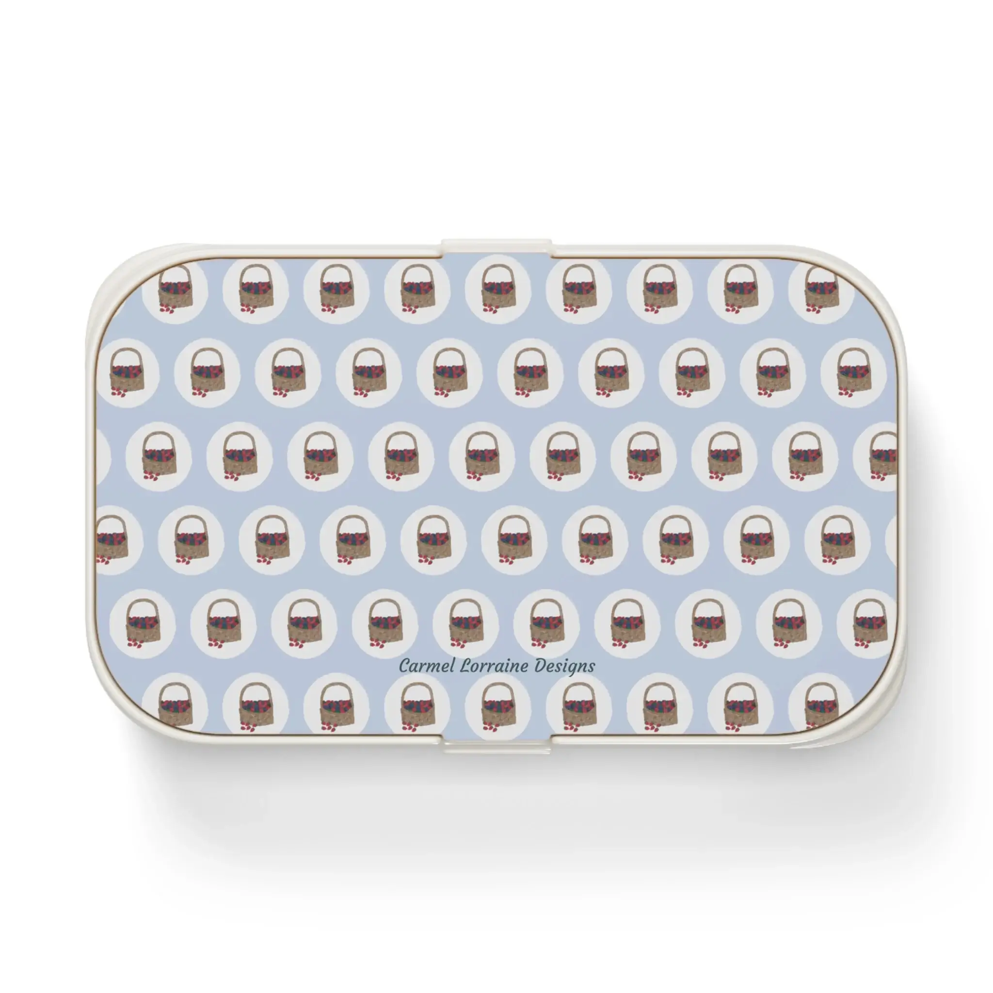 Basket of Berries bento lunchbox with berry pattern on light blue background and wooden lid.