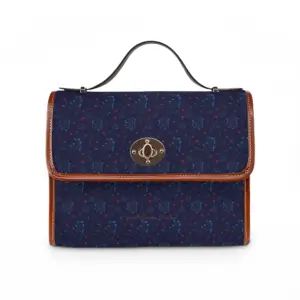Woodland Bloom crossbody handbag featuring a deep navy floral pattern with lilac, saffron, magenta, and periwinkle wildflowers. Medium rectangular waterproof canvas bag with tan PU leather handles and adjustable crossbody strap.