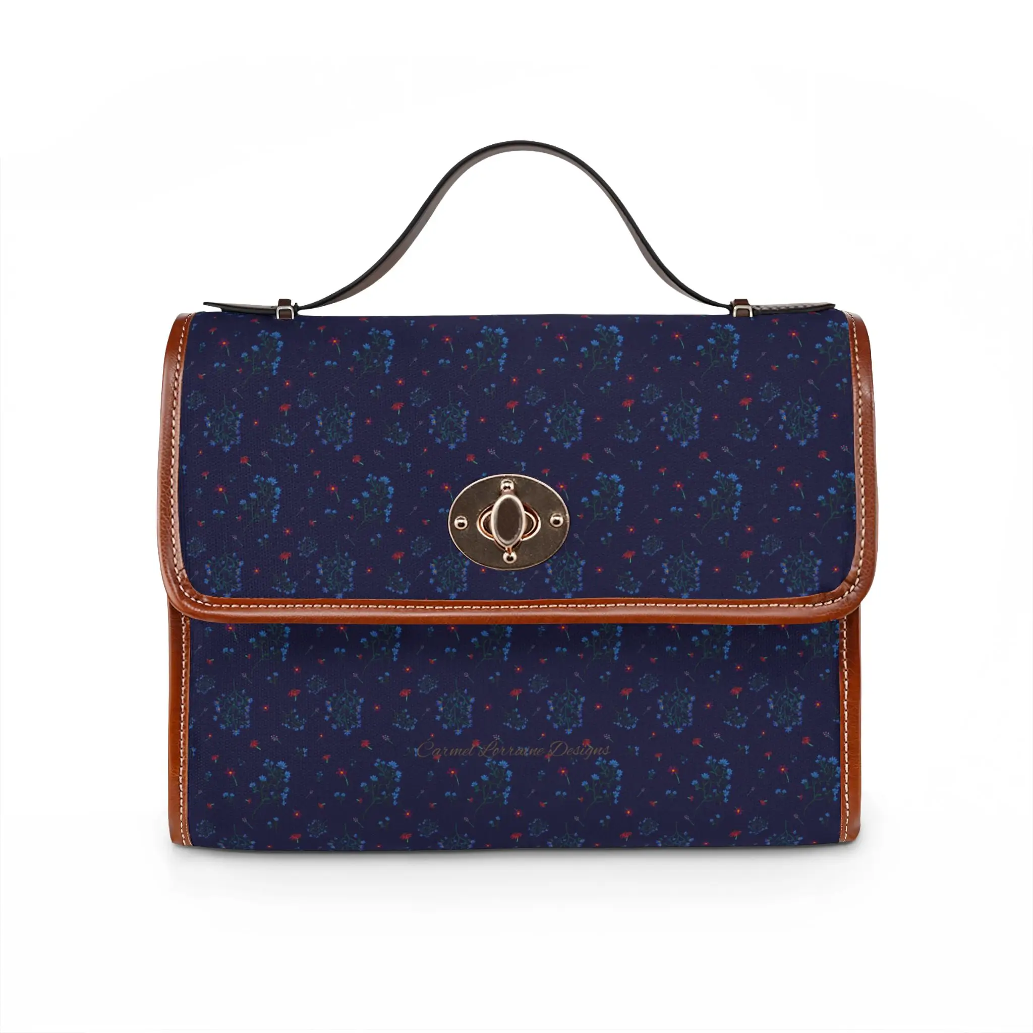 Woodland Bloom crossbody handbag featuring a deep navy floral pattern with lilac, saffron, magenta, and periwinkle wildflowers. Medium rectangular waterproof canvas bag with tan PU leather handles and adjustable crossbody strap.
