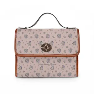 Lavender Breeze crossbody handbag featuring a soft lilac floral pattern with periwinkle blue, saffron, magenta, and berry-toned flowers. Medium-sized waterproof canvas bag with tan PU leather handles and an adjustable shoulder strap.